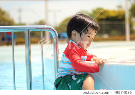 Children playing in the pool Children playing in the pool 49974086