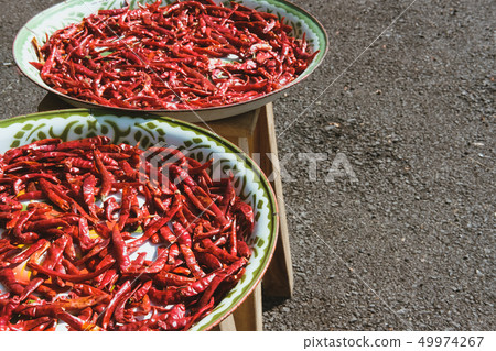 drying red chili on tray. dried hot chilli pepper drying red chili on tray. dried hot chilli pepper 49974267