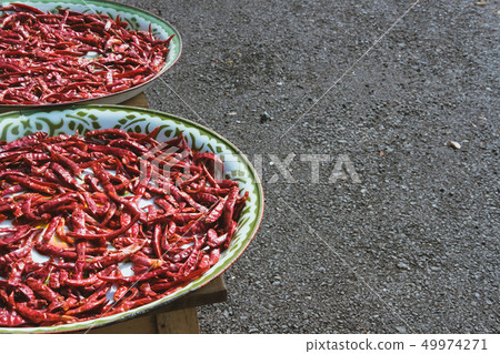 drying red chili on tray. dried hot chilli pepper drying red chili on tray. dried hot chilli pepper 49974271