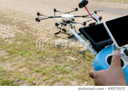 man controlling agriculture drone. remote controller 49975023