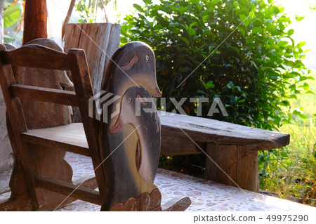 wooden chair table on cozy terrace with garden view wooden chair table on cozy terrace with garden view 49975290
