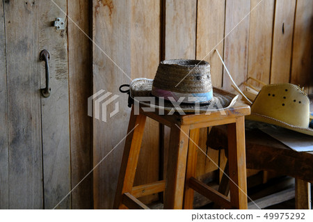 wicker hat on wooden stool at rural country house wicker hat on wooden stool at rural country house 49975292