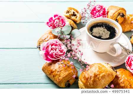Mini fresh croissants bun and coffee Mini fresh croissants bun and coffee 49975341