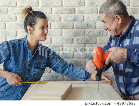 Daughter helps hersenior father to renovate house or apartment 49978682