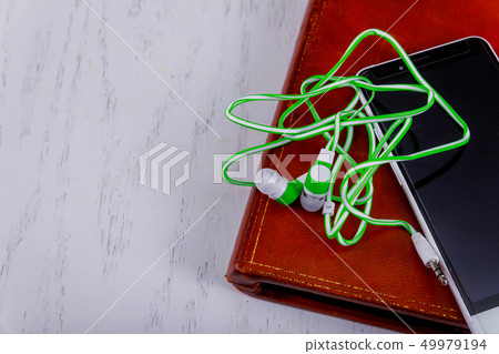 Headphones, mobile phone and books on audio book Headphones, mobile phone and books on audio book 49979194