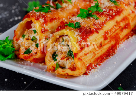 Cannelloni pasta meat and bechamel sauce and basil 49979417