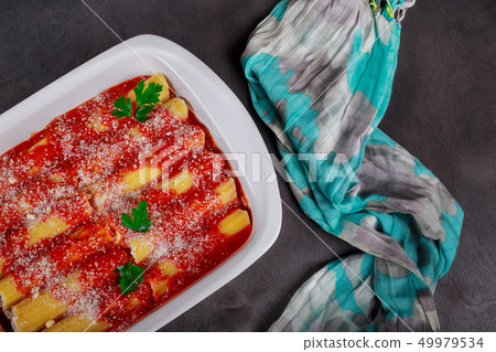 Cannelloni with spinach and ricotta baked in sauce 49979534