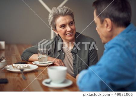 Happy smiling aged couple sitting in cafe Happy smiling aged couple sitting in cafe 49981006