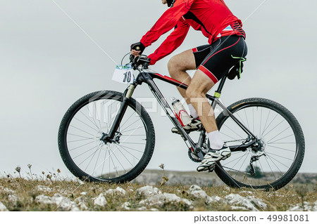 athlete cyclist riding mountain bike 49981081