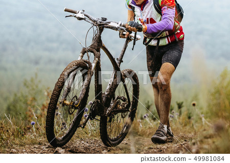 dirty cyclist climbing mountain trail dirty cyclist climbing mountain trail 49981084