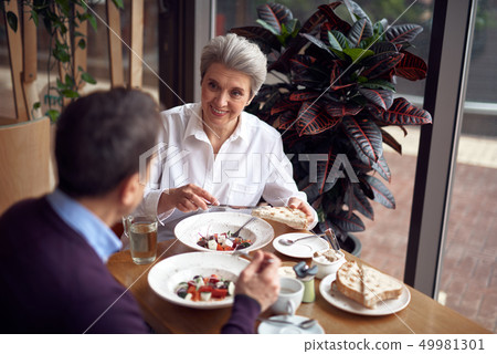 Aged smiling elegant woman with roasted bread 49981301