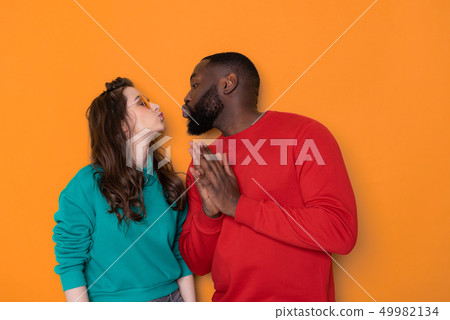Half length portrait of happy interracial couple in studio 49982134