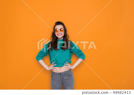 Waist up of attractive fashionable Caucasian girl wearing stylish eyeglasses in studio 49982413