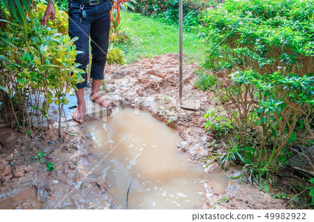 male plumber are repair broken pipe in hole  49982922