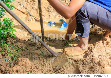 male plumber are repair broken pipe in hole  49982924