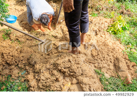 male plumber are repair broken pipe in hole 49982929