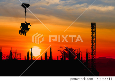 Silhouette construction worker on crane hook Silhouette construction worker on crane hook 49983311