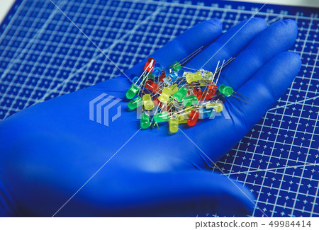 Engineer holding colorful RGB light-emitting diodes in arms 49984414