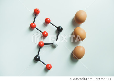 Raw hen eggs lying on white table in laboratory room Raw hen eggs lying on white table in laboratory room 49984474