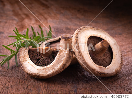 portobello mushrooms over old wood background 49985772