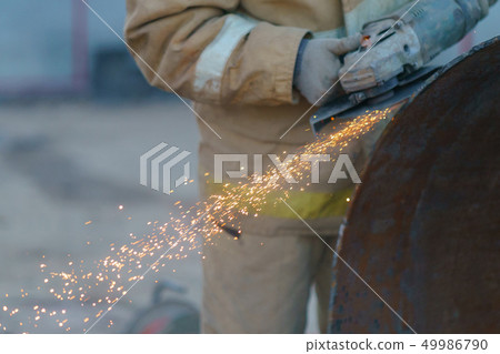 Man's hands that cutting and grinding a metal 49986790
