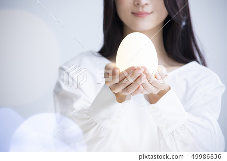 A woman with eggs A woman with eggs 49986836