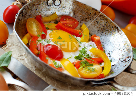 Fried egg with a bell pepper and tomatoes Fried egg with a bell pepper and tomatoes 49988104