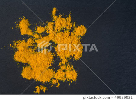 Heap of turmeric.Turmeric powder. 49989021