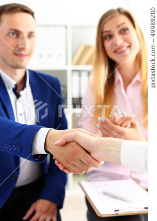 Man in suit shake hand as hello in office closeup 49989280