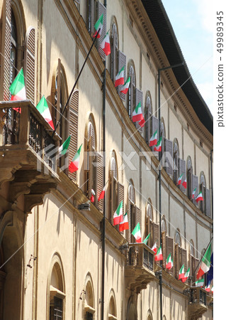 Italian flags outside of a windows 49989345