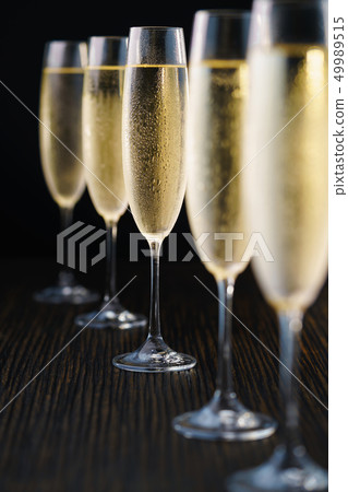 Cold sparkling wine, close up. Black background. Cold sparkling wine, close up. Black background. 49989515