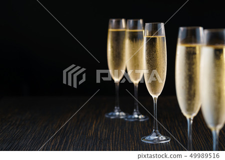 Cold sparkling wine, close up. Black background. Cold sparkling wine, close up. Black background. 49989516