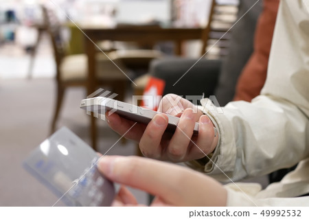 Motion of woman typing credit card number Motion of woman typing credit card number 49992532