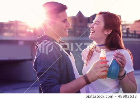Laughing ginger girl in white t-shirt spending time with her handsome boyfriend 49992638