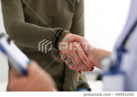 Medicine doctor shake hands as hello with female patient 49993200