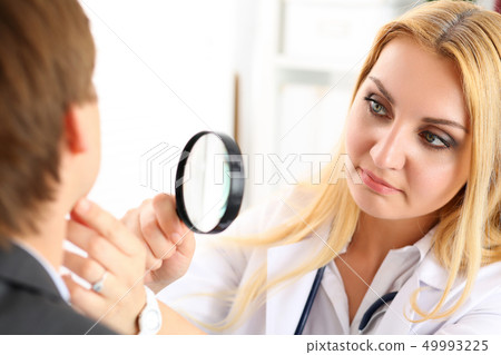 Beautiful female medicine doctor with serious face Beautiful female medicine doctor with serious face 49993225
