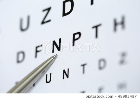 Silver ballpoint pen pointing to letter in eyesight check table Silver ballpoint pen pointing to letter in eyesight check table 49993487