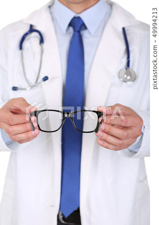 Male medicine doctor hands giving pair of black glasses to patient 49994213