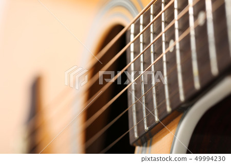 Classic acoustic guitar at weird and unusual perspective Classic acoustic guitar at weird and unusual perspective 49994230