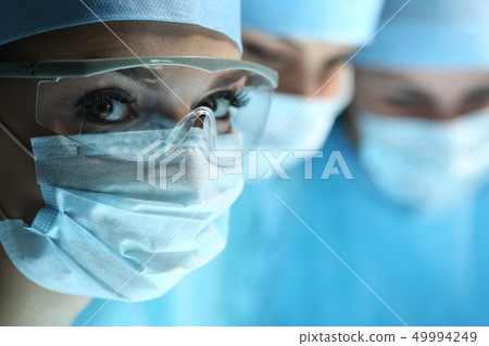 Female surgeon portrait looking in camera Female surgeon portrait looking in camera 49994249