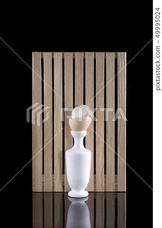 Still life with a white vase and broken chicken 49995024