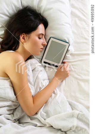 Young beautiful brunette woman portrait lying in bed sleeping Young beautiful brunette woman portrait lying in bed sleeping 49995892