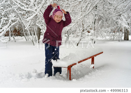 Little girl in winter outdoors 49996313