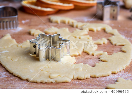 Cutting out shapes for Linzer Christmas cookies 49996455