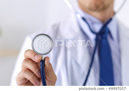 Male medicine doctor hand holding stethoscope head 49997057