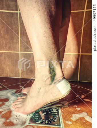 Shovering with painful skin on foot with plaster Shovering with painful skin on foot with plaster 49997155