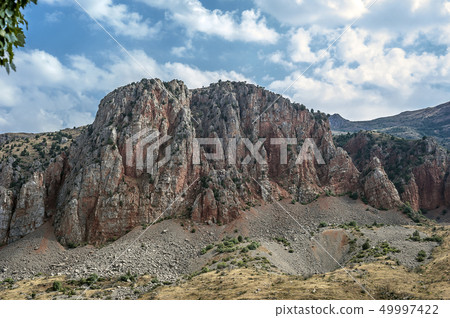 Picturesque red cliffs in front of the monastery 49997422