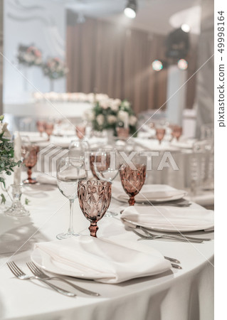 Wine glasses on round Banquet table served. Interior of restaurant for wedding dinner, ready for Wine glasses on round Banquet table served. Interior of restaurant for wedding dinner, ready for 49998164