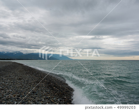 Sea waves on a pebble beach Sea waves on a pebble beach 49999203