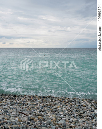 Sea waves on a pebble beach Sea waves on a pebble beach 49999204